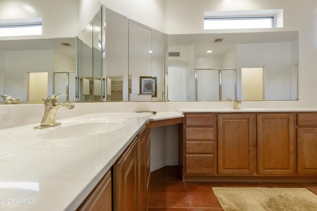 bathroom with vanity, an enclosed shower, tile patterned flooring, and a wealth of natural light