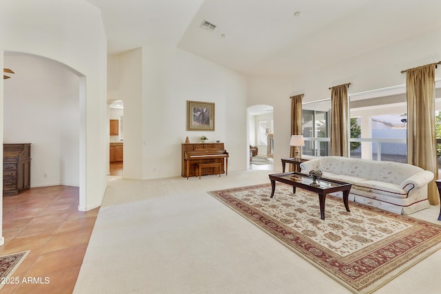 tiled living room with high vaulted ceiling