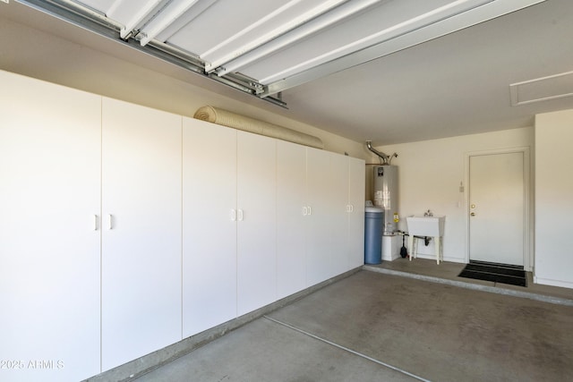 garage featuring sink and gas water heater