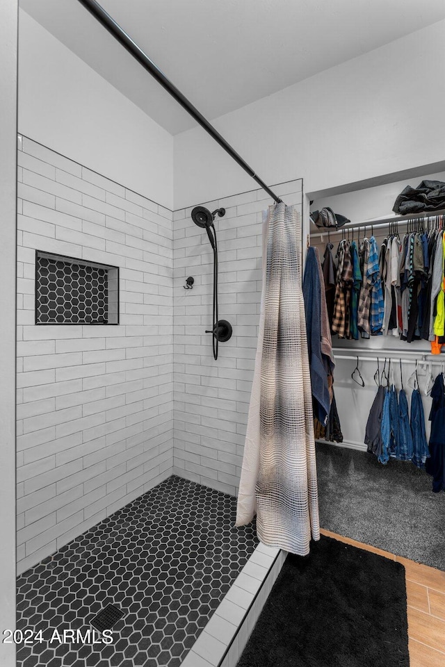 bathroom featuring curtained shower and hardwood / wood-style floors