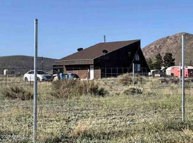 6075 E San Carlos Dr, Pearce, AZ 85625 - view of property exterior with a mountain view and fence