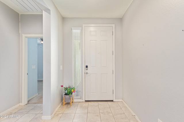 tiled entrance foyer with ceiling fan