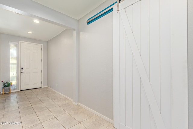 tiled foyer entrance featuring a barn door