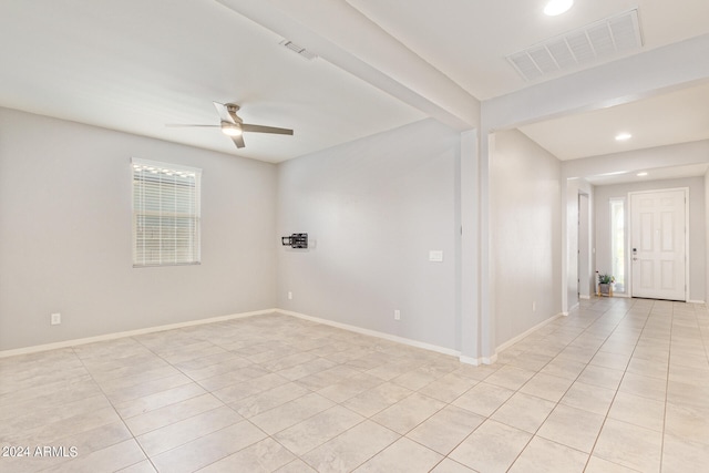 unfurnished room with ceiling fan and light tile patterned flooring