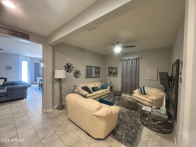 living room with ceiling fan and light tile patterned floors