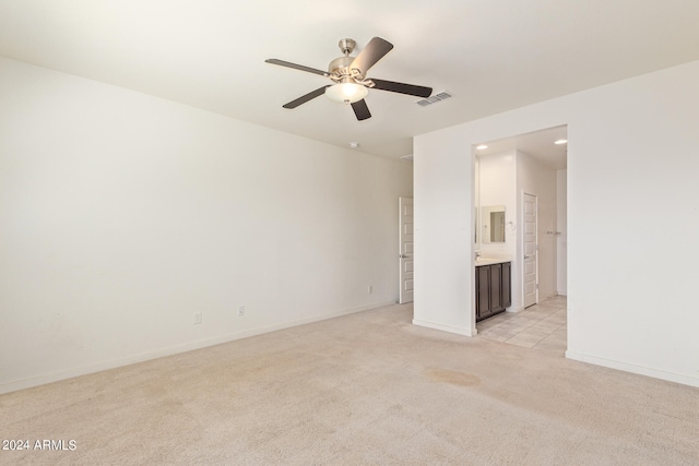 empty room with light colored carpet and ceiling fan