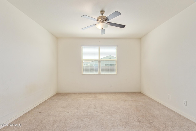 empty room with ceiling fan and light carpet