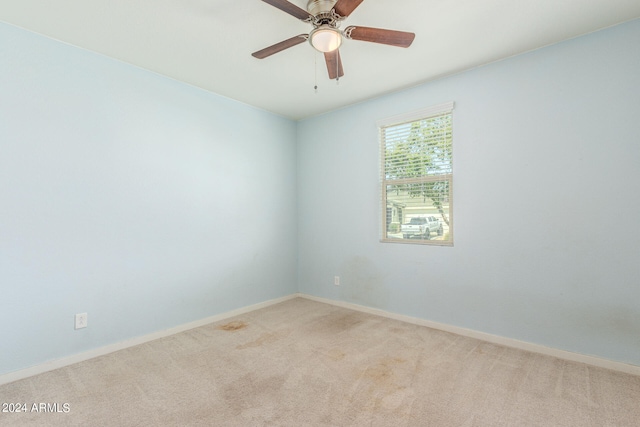 carpeted empty room featuring ceiling fan