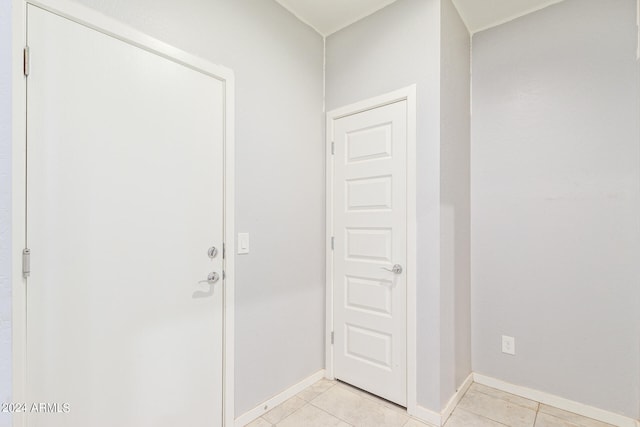 doorway with light tile patterned floors