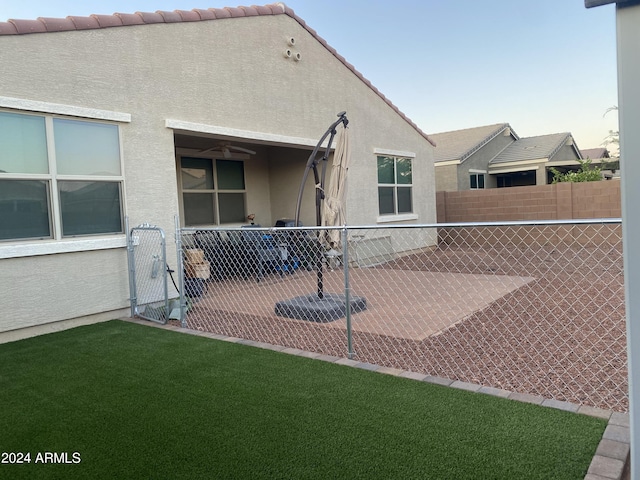 back of property featuring a lawn and a patio area