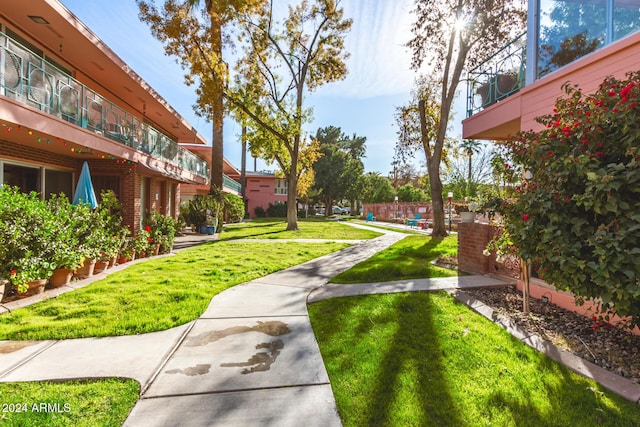 view of property's community with a lawn