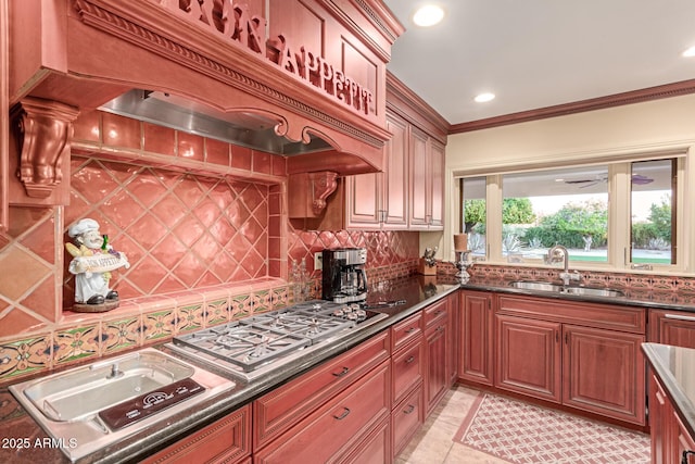 kitchen with sink, crown molding, backsplash, stainless steel gas cooktop, and custom exhaust hood