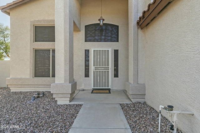 property entrance with stucco siding