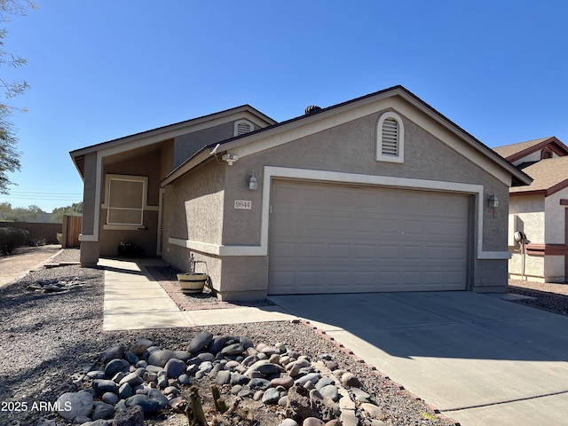 view of front of home featuring driveway, a garage, and stucco siding