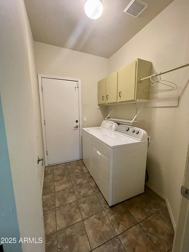 laundry area featuring cabinet space, washing machine and dryer, and visible vents