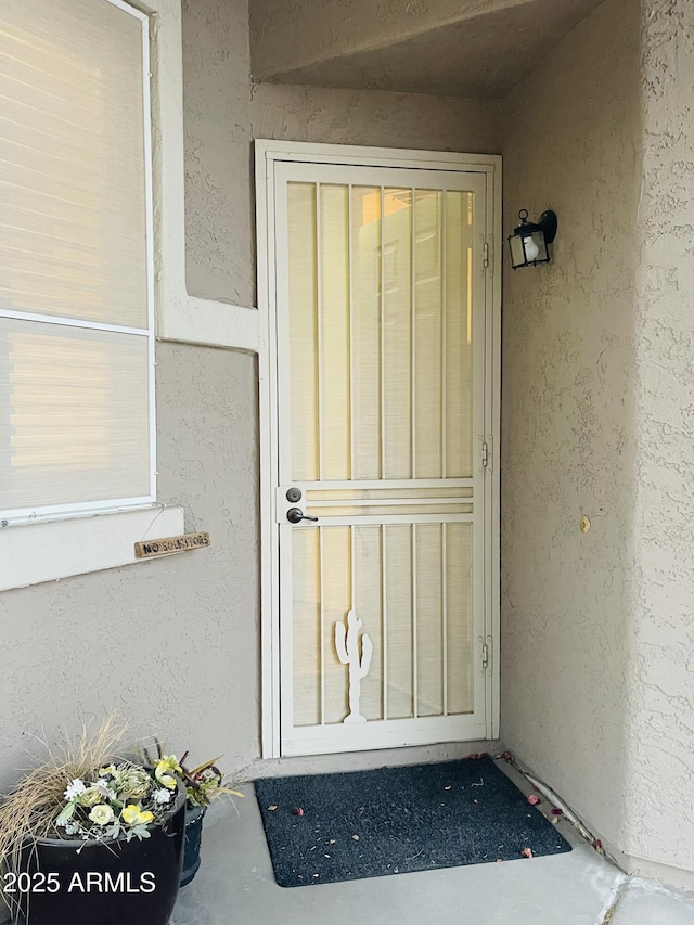 doorway to property with stucco siding