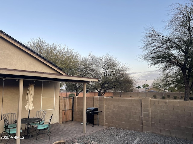 view of yard featuring fence and a patio