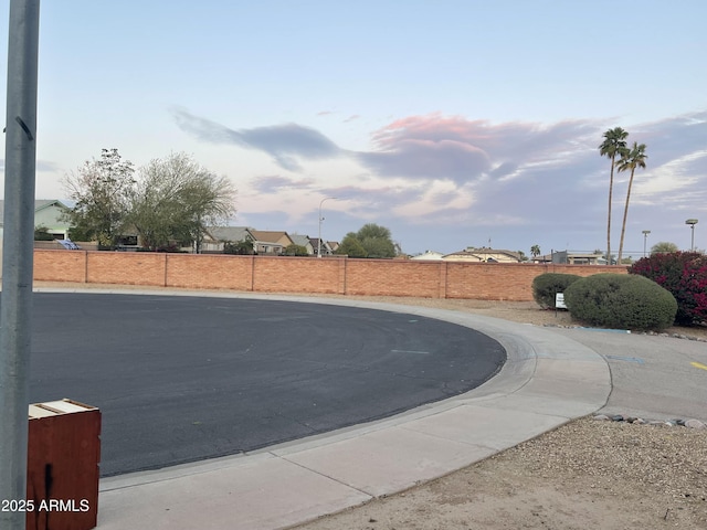 view of road featuring street lighting, curbs, and sidewalks