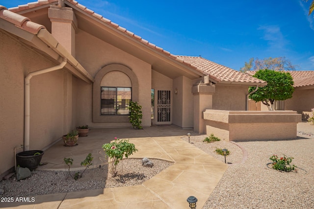 9243 W Kimberly Way, Peoria, AZ 85382 - doorway to property with a tiled roof, a patio, fence, and stucco siding