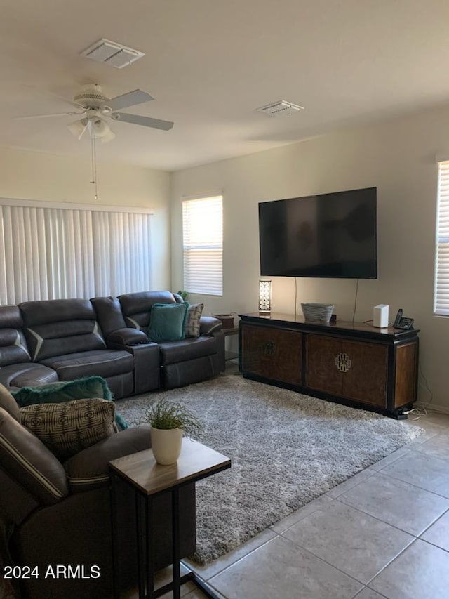 tiled living room with ceiling fan