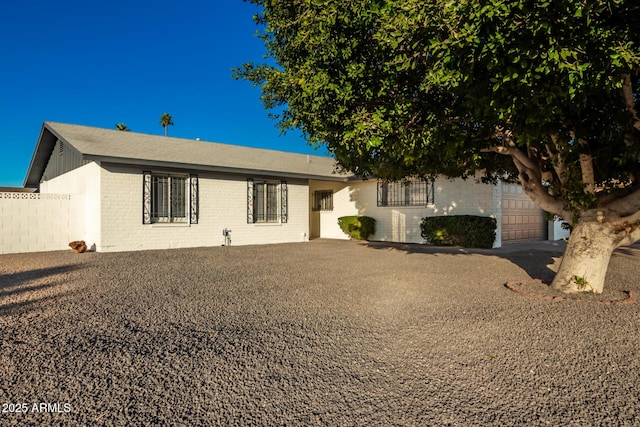 rear view of property with a garage