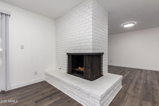 room details with wood-type flooring and a brick fireplace