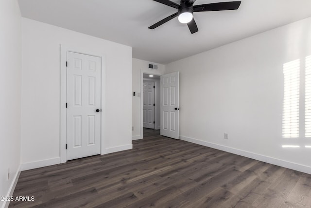 unfurnished bedroom featuring dark hardwood / wood-style floors and ceiling fan