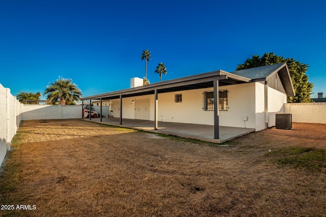 back of house featuring central AC and a patio area