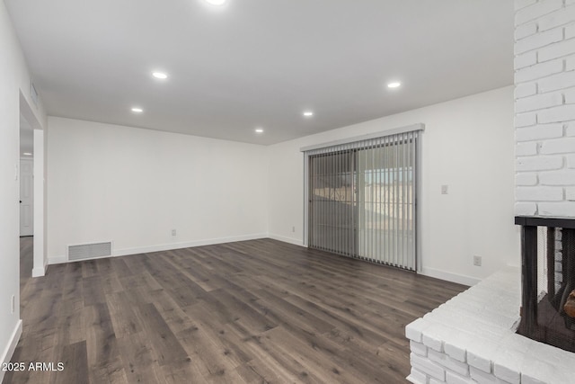 unfurnished living room with dark wood-type flooring