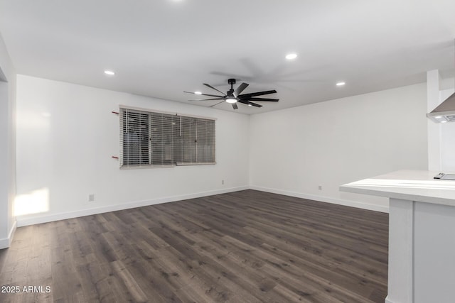 unfurnished living room featuring ceiling fan and dark hardwood / wood-style floors