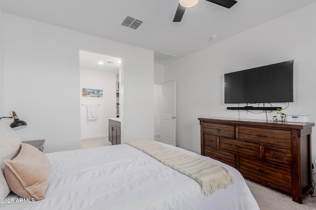 carpeted bedroom featuring ensuite bath and ceiling fan