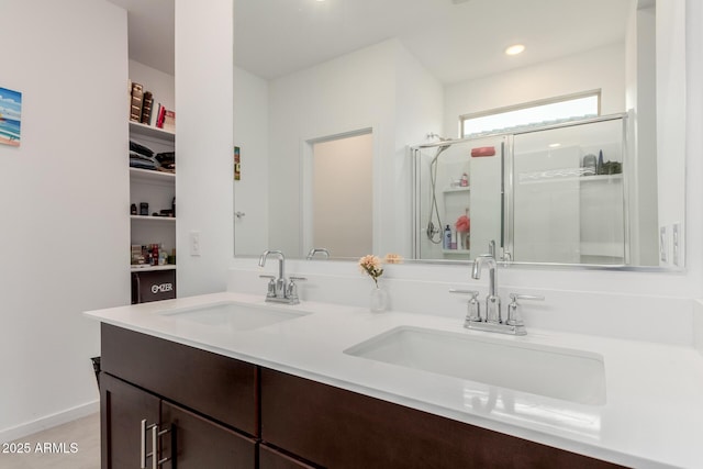 bathroom with vanity and a shower with shower door