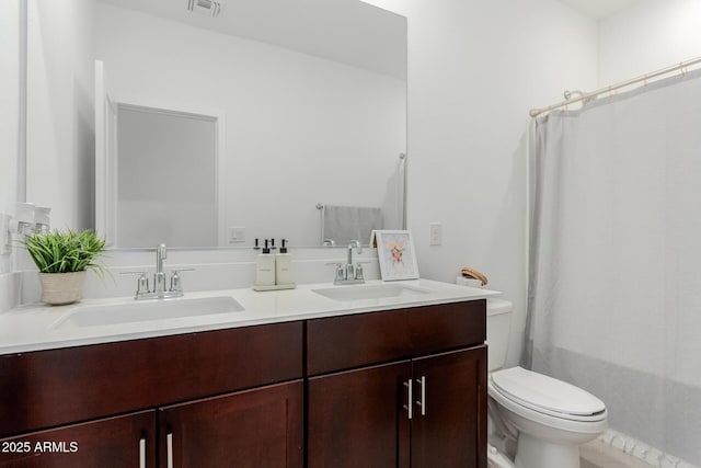 bathroom featuring vanity and toilet