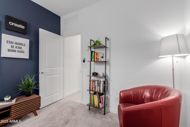 living area featuring light carpet