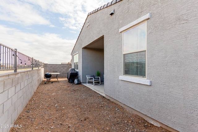 view of side of property featuring a patio area