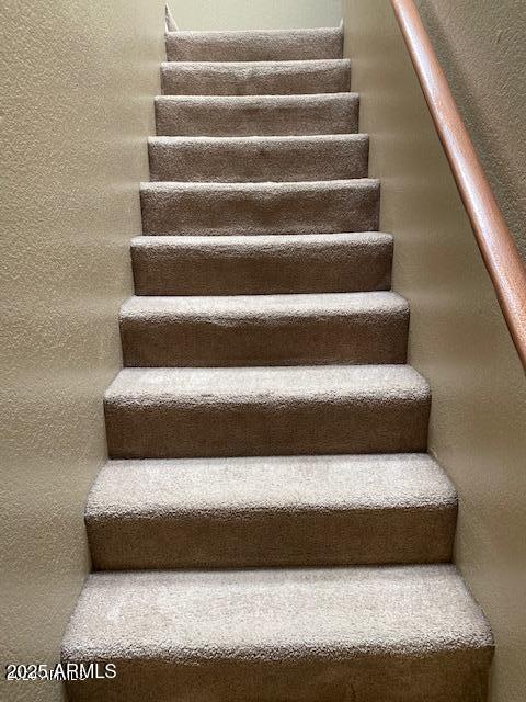 stairway with a textured wall