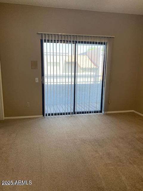 empty room with carpet floors and baseboards