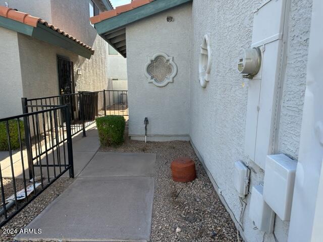 view of side of property featuring a tiled roof and stucco siding