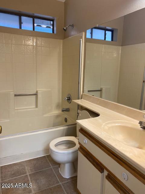 full bath with shower / bathtub combination, vanity, toilet, and tile patterned floors