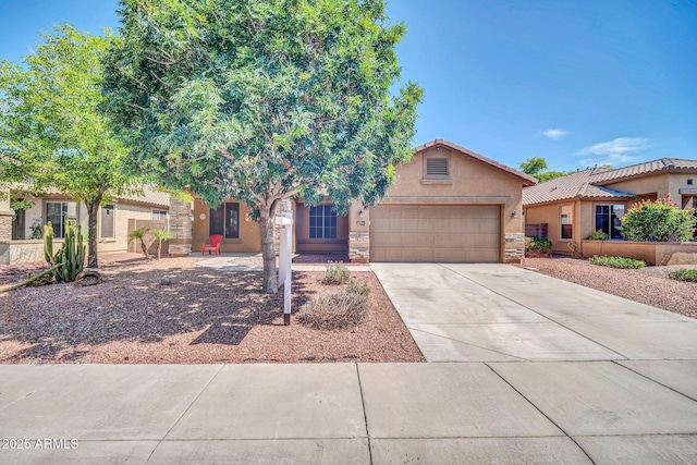 11318 W Monte Vista Rd, Avondale, AZ 85392 - view of front facade featuring an attached garage, stucco siding, stone siding, and driveway