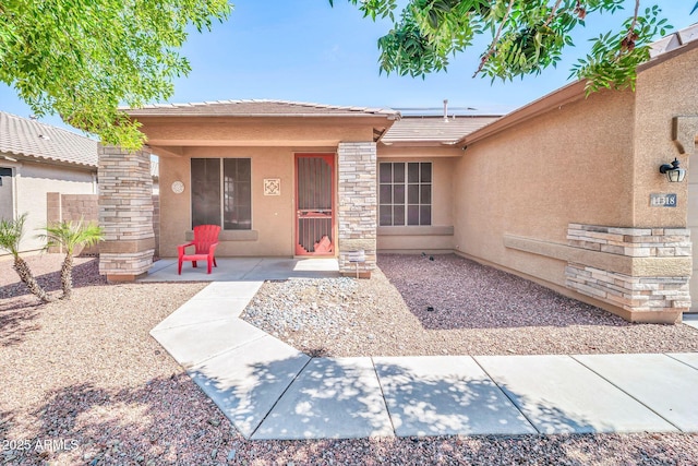 11318 W Monte Vista Rd, Avondale, AZ 85392 - view of front facade with stucco siding, solar panels, a tile roof, and stone siding
