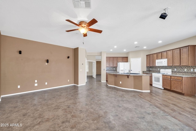11318 W Monte Vista Rd, Avondale, AZ 85392 - kitchen featuring white appliances, tasteful backsplash, brown cabinetry, ceiling fan, and open floor plan
