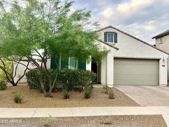 20644 W Mariposa St, Buckeye, AZ 85396 - view of front of home with decorative driveway, stucco siding, a garage, and a tiled roof