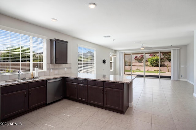 20644 W Mariposa St, Buckeye, AZ 85396 - kitchen featuring stainless steel dishwasher, a peninsula, plenty of natural light, a sink, and recessed lighting