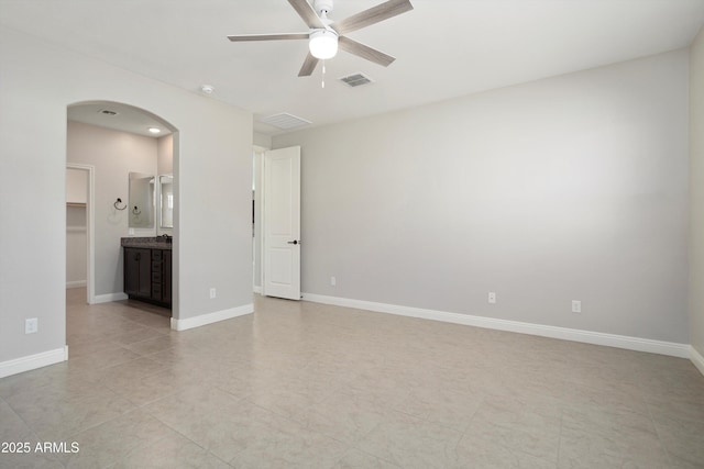 20644 W Mariposa St, Buckeye, AZ 85396 - spare room with a ceiling fan, arched walkways, baseboards, and light tile patterned floors