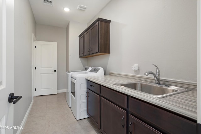 20644 W Mariposa St, Buckeye, AZ 85396 - laundry room featuring independent washer and dryer, cabinet space, baseboards, and light tile patterned flooring