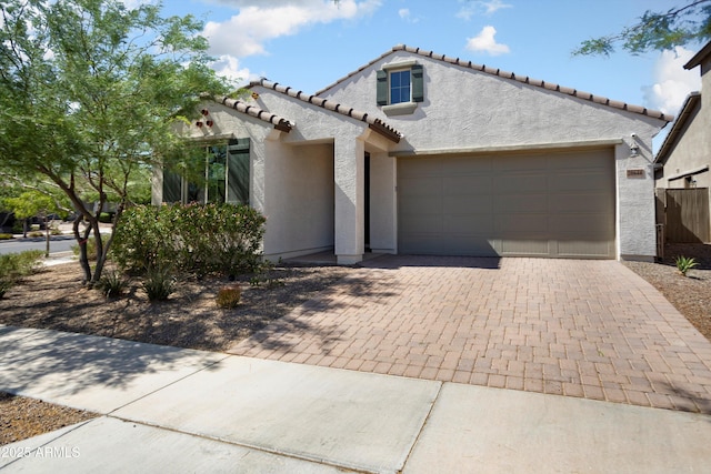 20644 W Mariposa St, Buckeye, AZ 85396 - mediterranean / spanish home featuring stucco siding, an attached garage, decorative driveway, and a tile roof