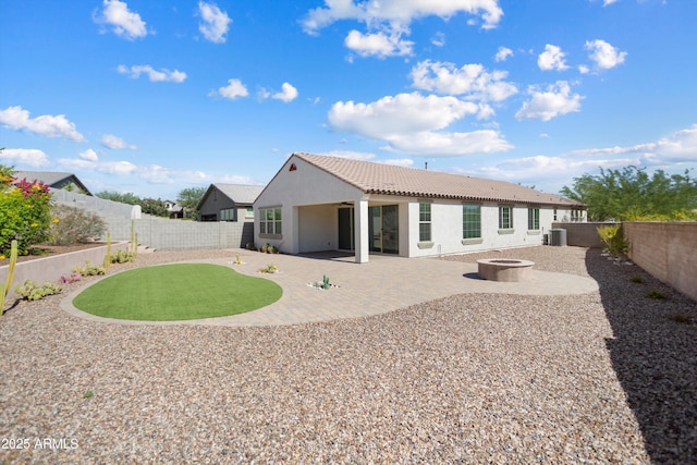 20644 W Mariposa St, Buckeye, AZ 85396 - rear view of property featuring stucco siding, a fire pit, a patio, central AC, and a tiled roof