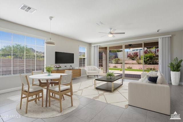 20644 W Mariposa St, Buckeye, AZ 85396 - living room featuring a ceiling fan, light tile patterned floors, and baseboards