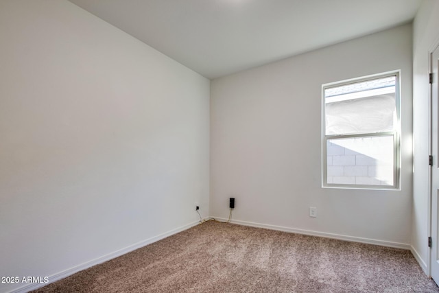 spare room featuring light colored carpet